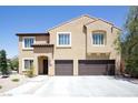 Two-story stucco home boasts a tile roof, two-car garage, and well-maintained landscaping at 176 Jay Porter Ave, Henderson, NV 89002