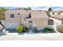 Attractive two-story home featuring a tile roof, attached garage, and manicured landscaping at 185 Renville Ct, Henderson, NV 89074