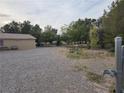 Spacious gravel area next to the home, offering ample parking and recreational space at 1930 N Murphy St, Pahrump, NV 89060
