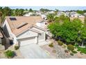 Beautiful single-story home from above, boasting a lovely front yard, two-car garage, and solar panels on the roof at 1978 Kachina Mountain Dr, Henderson, NV 89012