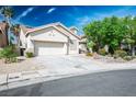 Attractive single-story home with a two-car garage, lush front yard and desert landscaping for easy maintenance at 1978 Kachina Mountain Dr, Henderson, NV 89012