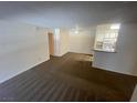 Spacious living room with neutral carpet flowing to the kitchen at 2200 S Fort Apache Rd # 2113, Las Vegas, NV 89117