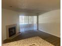 Cozy living area featuring a fireplace, carpet, and sliding glass doors at 2200 S Fort Apache Rd # 2113, Las Vegas, NV 89117