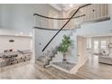 Elegant staircase with modern railings and stylish flooring creates a grand entrance in this home at 2224 Lucerne Ct, Henderson, NV 89014