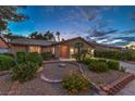 Charming single-story home with brick accents, a well-manicured front yard, and vibrant desert landscaping at 2231 Marlboro Dr, Henderson, NV 89014