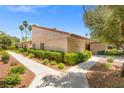 Exterior showcases desert landscaping with mature trees and walkway leading to the front door at 2480 Domingo St, Las Vegas, NV 89121