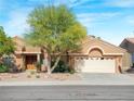 Beautiful single-story home featuring a two-car garage and desert landscaping at 2540 Faiss Dr, Las Vegas, NV 89134