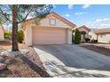 Well-maintained single-story home featuring a spacious two-car garage and attractive desert landscaping at 2605 Lotus Hill Dr, Las Vegas, NV 89134