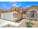 Charming two-story home featuring a three-car garage, double door entry, and desert landscaping at 2713 Beachside Ct, Las Vegas, NV 89117