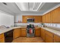 Bright kitchen with stainless steel appliances, oak cabinets, and a tile backsplash at 3425 Creek River Dr, Las Vegas, NV 89129