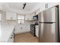 Updated kitchen featuring white cabinets, stainless appliances, and modern fixtures at 3608 Pintadas St # 204, Las Vegas, NV 89108