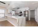 Stylish kitchen with white cabinets, stainless steel appliances, and quartz countertops at 3608 Pintadas St # 204, Las Vegas, NV 89108