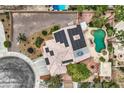 Birds-eye view of a home featuring solar panels, lush landscaping, a pool, and a backyard patio at 3619 Bixbee Ct, Las Vegas, NV 89129