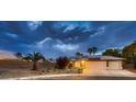 Inviting single-story home with a two-car garage, solar panels, and desert landscaping at 3619 Bixbee Ct, Las Vegas, NV 89129