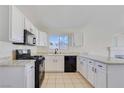 Bright kitchen features white cabinetry, granite countertops, and stainless steel appliances at 3808 Lilac Haze St, Las Vegas, NV 89147