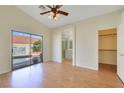 Spacious main bedroom with wood floors, ceiling fan, closet, and bathroom access at 3808 Lilac Haze St, Las Vegas, NV 89147