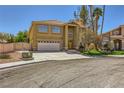 Inviting two-story home featuring a spacious driveway leading to an attached garage and a neatly maintained lawn at 4 Bishopsgate Ter, Henderson, NV 89074