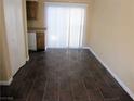 Open dining area with dark tile floors, natural light, and a sliding glass door leading to outdoor space at 500 S 13Th St # C6, Las Vegas, NV 89101