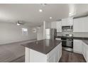 Open-concept kitchen features stainless steel appliances and a center island at 6245 Blood Lily Ave, Las Vegas, NV 89122