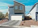 Contemporary two-story home with two-car garage, clean lines, and low maintenance landscaping at 63 Harrison Rose Ct, Las Vegas, NV 89110