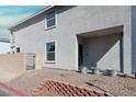 Single-story home showcasing a gated entrance, low-maintenance landscaping, and textured exterior at 63 Harrison Rose Ct, Las Vegas, NV 89110