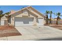 Single-story home boasting a spacious driveway, two-car garage, and low-maintenance desert landscaping at 6328 Yankee Meadow Cir, Las Vegas, NV 89130