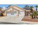 A single-story home with a two-car garage and a well-maintained yard featuring desert landscaping at 6328 Yankee Meadow Cir, Las Vegas, NV 89130
