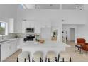 Bright, open kitchen featuring white cabinets, a large island with seating, and modern appliances at 6700 Pine Needle Ct, Las Vegas, NV 89108