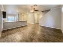 Open concept living and dining area with wood floors and contemporary design, open staircase at 6777 Wormwood Ln, Las Vegas, NV 89148