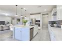 Bright, open kitchen featuring a large center island, stainless steel appliances, and modern finishes at 701 Monroe Hill Pl, Henderson, NV 89011