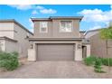 Attractive two-story home showcases a two-car garage, tidy landscaping and a classic facade at 7128 Port Stephens St, North Las Vegas, NV 89084