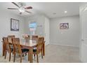 Bright dining room with a wooden table set for six and neutral walls at 748 Dellenbaugh Ct, Las Vegas, NV 89178