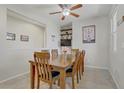 Dining room features a table set for six with neutral walls and tiled flooring at 748 Dellenbaugh Ct, Las Vegas, NV 89178