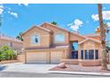 Two-story home featuring a well-maintained stucco exterior, tile roof, and a spacious two-car garage at 7751 Locke Haven Dr, Las Vegas, NV 89123