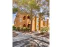 Beautiful condo building featuring desert landscaping and mature shade trees at 7950 W Flamingo Rd # 2065, Las Vegas, NV 89147