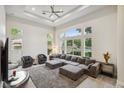 Bright living room features large windows, a ceiling fan, and an open concept floor plan at 801 Aquitaine Ct, Las Vegas, NV 89145