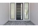 An elegant foyer featuring modern front door with sidelights and tile flooring at 8721 Robinson Ridge Dr, Las Vegas, NV 89117