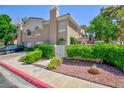 Beautiful townhome exterior with mature trees and manicured shrubbery at 915 Graceful Moon Ave, Henderson, NV 89015