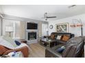 Comfortable living room with fireplace, ceiling fan and lots of natural light at 915 Graceful Moon Ave, Henderson, NV 89015