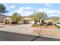 Beautiful single-story home with desert landscaping, spacious driveway, and attached two-car garage at 925 Crescent Falls St, Henderson, NV 89011