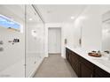Sleek bathroom boasts a walk-in shower, double vanity with modern fixtures, and bright natural light at 9815 Evergreen Pine St, Las Vegas, NV 89166