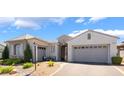 Beautiful exterior view of a single-story home with a two-car garage and well-maintained landscaping at 10579 Garden Rose Dr, Las Vegas, NV 89135