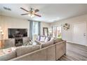 Stylish living room with a comfortable gray sofa, wood-look floors, and patio access at 10636 Colter Bay Ct, Las Vegas, NV 89129