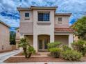 Inviting two-story home with desert landscaping and covered porch features an elegant double-door entryway at 1115 Aldenwood Ave, Las Vegas, NV 89123
