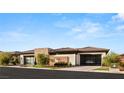 Beautiful single-story home with modern design, glass garage doors, and well-maintained landscaping at 11152 San Terrazo Pl, Las Vegas, NV 89141