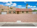 Charming single-story home boasts a desert landscape and a well-maintained red tile roof at 138 Palma Del Rio, Las Vegas, NV 89110