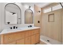 Stylish bathroom with double vanity, arched mirrors, and walk-in shower at 1705 Imperial Cup Dr, Las Vegas, NV 89117