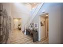 Home entryway featuring decorative art pieces, tile flooring and a staircase leading to the upper level at 2198 Maderno St, Henderson, NV 89044