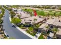 Aerial view of a home showcasing its well-manicured landscaping and proximity to a golf course at 2539 Turtle Head Peak Dr, Las Vegas, NV 89135