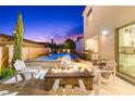 Relaxing backyard featuring a pool, spa, outdoor kitchen, and fire pit for year-round enjoyment at 2710 Marchetti Pl, Henderson, NV 89044